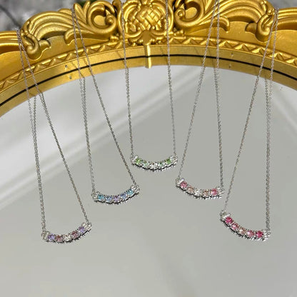 Set of four necklaces with colorful stones on a gold frame