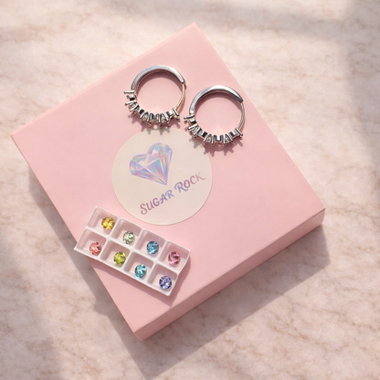 Hoop earrings with gemstones on a pink display card with 'SUGAR ROCK' branding.